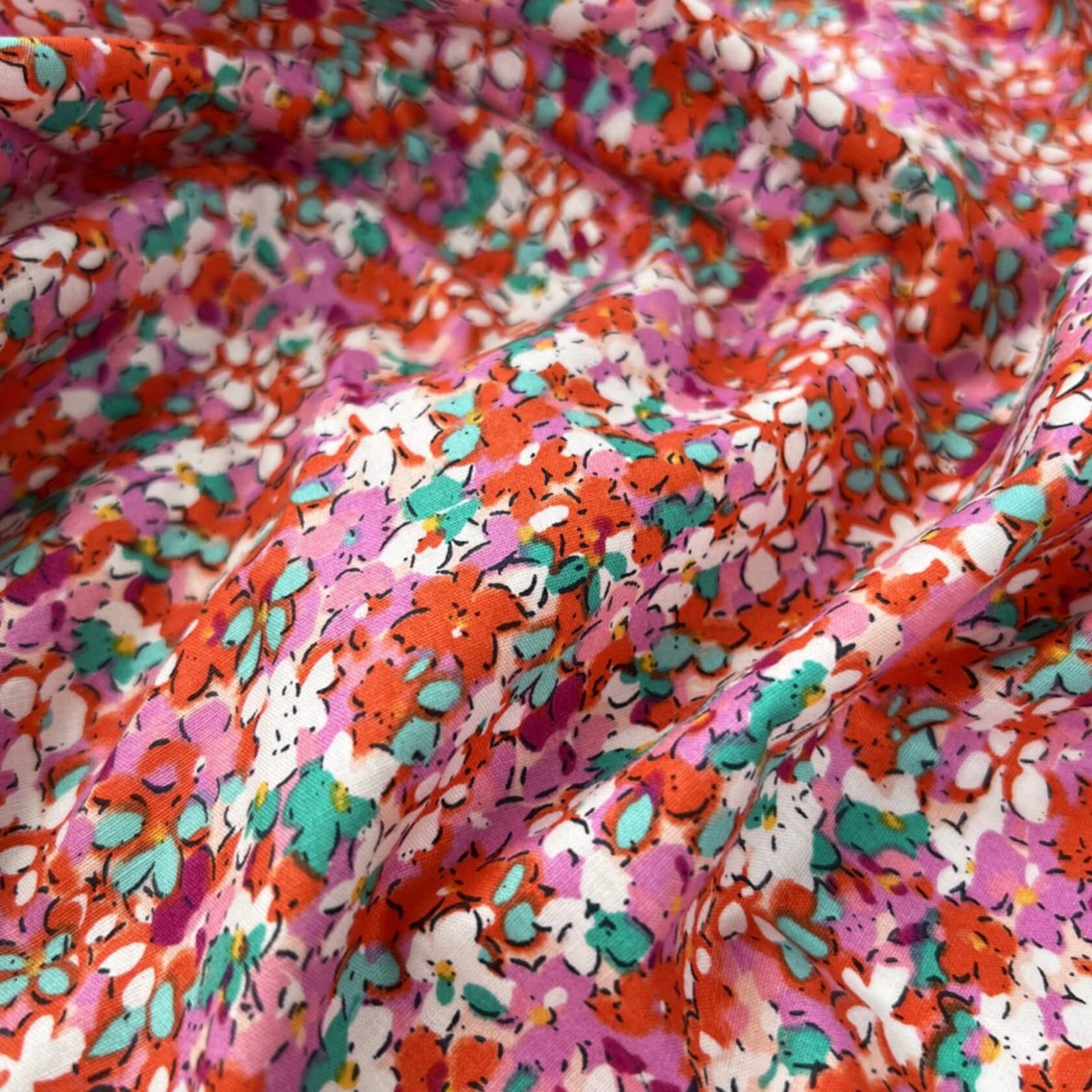 A delicate, small-scale floral fabric pattern.
